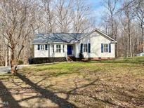 Charming single-Gathering home featuring light siding, dark shutters, and a well-manicured front yard at 228 Kentucky Dr, Archer Lodge, NC 27527