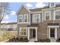 Charming townhome featuring brick and vertical siding and large windows at 231 Frosted Iris Lane Ln # 174, Garner, NC 27529