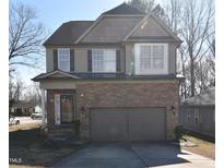 Charming two-story home featuring stone accents, attached two-car garage, and a well-maintained front yard at 2701 Erinridge Road Rd, Raleigh, NC 27610