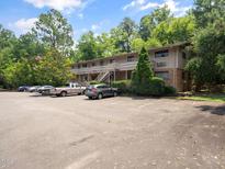 Apartment building with ample parking nestled in a well-maintained and tree-lined community at 3 Shepherd Ln # Bldg C, Chapel Hill, NC 27514