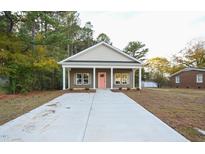 Charming single-story home with a welcoming front porch and a long concrete driveway at 302 S Eastwood Dr, Benson, NC 27504