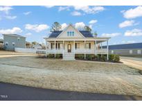 Charming two-story home featuring a large front porch, well-maintained lawn, and inviting curb appeal at 304 Ashley Woods Ct, Clayton, NC 27527