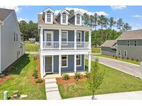 Charming two-story home featuring a welcoming front porch and well-maintained landscaping at 304 White Oak Garden Way # 214, Garner, NC 27529