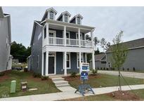 Charming two-story home with a welcoming front porch and manicured lawn at 304 White Oak Garden Way # 214, Garner, NC 27529