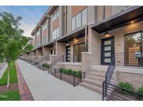 Modern townhome exteriors featuring brick, wood paneling, metal accents, and landscaped entryways at 777 Willard St, Durham, NC 27701