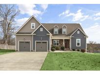 Charming two-story home featuring a two-car garage and a well-manicured front lawn at 1044 Butterfly Cir, Wake Forest, NC 27587