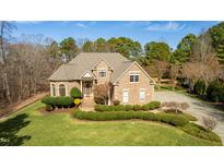 Beautiful two-story brick home with a well-manicured lawn and mature landscaping at 1408 Goldengate Ct, Raleigh, NC 27613