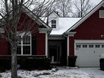 Charming red home featuring a snow-covered roof, an attached garage, and a well-manicured front yard at 152 Verrazano Pl, Clayton, NC 27520