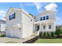Charming two-story home with a landscaped yard, inviting front porch, and a spacious two-car garage at 200 Gravel Brook Ct, Cary, NC 27519