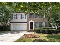 Charming two-story home with brick and vinyl siding, landscaped yard, and a two car garage at 2114 Frissell Ave, Apex, NC 27502