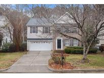 Charming two-story home with a well-maintained lawn, a two car garage, and brick and siding exterior at 2114 Frissell Ave, Apex, NC 27502