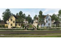 Charming new homes line a street, featuring colorful exteriors and inviting front yards at 2656 Welham Aly, Raleigh, NC 27608