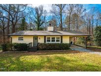 Charming single-story home with a welcoming front porch, tidy landscaping, and a convenient carport at 347 Carlton Dr, Chapel Hill, NC 27516
