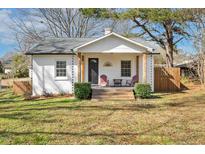 Charming home featuring a cozy front porch, manicured lawn, and mature trees at 403 Sallinger St, Knightdale, NC 27545