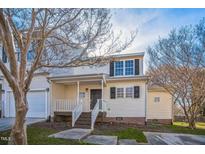 Charming two-story townhome with a covered front porch and neutral siding, offering a welcoming curb appeal at 4120 Standing Rock Way, Raleigh, NC 27604