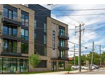 Modern building exterior with multiple balconies and stylish architectural details at 615 W Peace St # 406, Raleigh, NC 27605