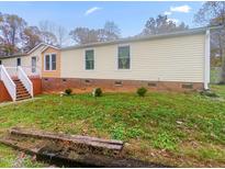Charming single-story home with vinyl siding, complemented by a well-maintained lawn and partial brick foundation at 6508 Treetop Ct, Snow Camp, NC 27349