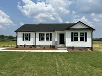 Charming new construction home with white siding, black trim, and well-maintained lawn at 73 Grace Pond Ave, Benson, NC 27504