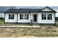 Charming home featuring a black roof, white siding, and complementing black shutters at 73 Grace Pond Ave, Benson, NC 27504