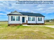 Charming single-story home featuring a well-maintained lawn, covered entrance, and classic architectural details at 73 Grace Pond Ave, Benson, NC 27504