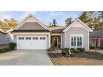 Charming single-story home featuring a two-car garage, manicured landscaping, and welcoming front entrance at 924 Calista Dr, Wake Forest, NC 27587
