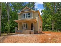 Two-story home with a charming front porch and light yellow exterior paint at 105 Sherwood Ln, Hillsborough, NC 27278