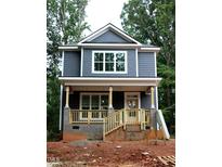 Charming two-story home featuring a welcoming front porch, neutral exterior paint, and beautiful new windows at 105 Sherwood Ln, Hillsborough, NC 27278