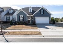 Charming single-Gathering home with a well-maintained lawn and a two-car attached garage at 117 Tiguan Ct, Holly Springs, NC 27540
