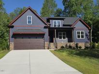 Charming craftsman style home featuring a two-car garage and inviting front porch at 140 Pilot Ridge Rd, Zebulon, NC 27597