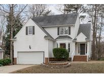 Charming two-story home with attached garage, gray roof, and landscaped yard at 1909 Somerset Hills Ct, Raleigh, NC 27604
