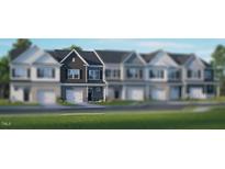 Attractive two-story townhome with a one-car garage and modern architectural details at 2205 Carcillar Dr, Apex, NC 27539