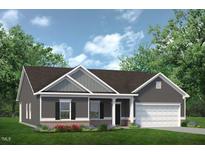 New construction home featuring gray siding, a brick foundation, and a well-manicured lawn at 316 Olivia Crossing Ct # 11, Four Oaks, NC 27524