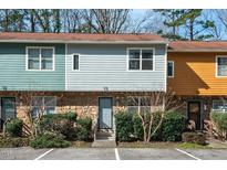 Charming townhouse featuring stone accents, colorful siding, and well-maintained landscaping at 3622 Colchester St # 13, Durham, NC 27707