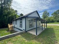 Charming single-story home featuring a covered porch and classic architectural design at 403 Spring Ct, Henderson, NC 27536