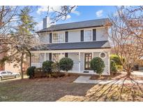 Charming two-story home with a inviting front porch and manicured landscaping at 4319 White Cliff Ln, Durham, NC 27712