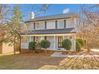 Charming two-story home with a well-manicured lawn, covered front porch, and beautiful landscaping at 4319 White Cliff Ln, Durham, NC 27712