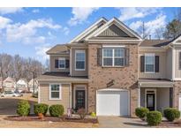 Charming two-story townhome with brick and siding, attached garage and well-manicured landscaping at 501 Historic Dr, Hillsborough, NC 27278