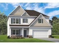 New two-story home featuring attached garage and stone accents, with a manicured lawn and a welcoming entryway at 508 Olivia Crossing Ct # 17, Four Oaks, NC 27524