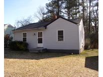 Cozy one-story home featuring vinyl siding, a new roof and trimmed front yard landscaping at 105 S Elizabeth St, Henderson, NC 27536