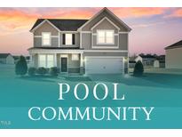 Charming two-story home featuring a two-car garage, well-maintained lawn, and inviting neutral-tone exterior at 109 Perignon Dr, Princeton, NC 27569