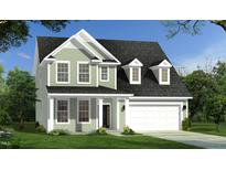 Charming two-story home with a two-car garage, covered front porch, and attractive landscaping at 141 Sugar Pine Drive, Franklinton, NC 27525