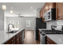 Modern kitchen features stainless steel appliances, gas range, white countertops, and an open floor plan at 1414 Excelsior Grand Ave, Durham, NC 27713