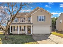 Charming two-story home with neutral siding, large windows, and a well-maintained lawn at 148 Brockton Ridge Dr, Garner, NC 27529