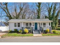 Charming single-story home featuring a welcoming porch and a freshly landscaped front yard at 302 St Augustine Ave, Raleigh, NC 27610