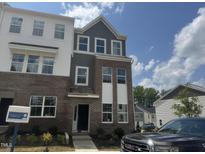 Charming multi-story townhome featuring a brick facade and light-filled windows at 304 Chesapeak Commons St # 146, Garner, NC 27529