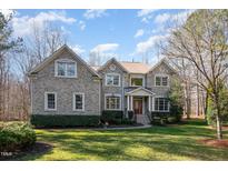 Charming two-story brick home with manicured lawn and mature landscaping at 4009 Brittabby Ct, Raleigh, NC 27606