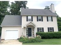 Charming two-story home featuring a well-maintained lawn, classic shutters and an attached garage at 4301 Red Banks Ct, Raleigh, NC 27616