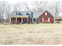 Charming brick home featuring a welcoming front porch and bright red shutters at 466 Oren Gaines Rd, Goldston, NC 27252