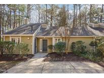 Charming single-story home with a mature landscaped yard and inviting front entrance at 5017 Pine Cone Dr, Durham, NC 27707