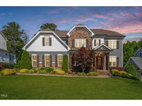 Charming two-story home with stone accents, landscaped yard, and a welcoming entrance at 5019 Neiman Cv, Raleigh, NC 27612